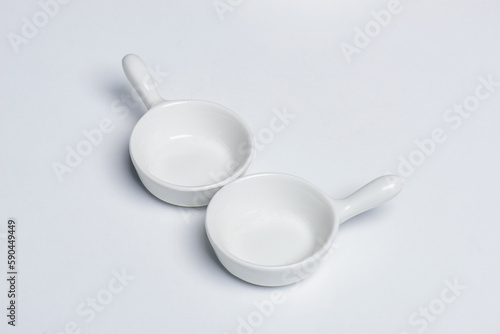 Two small spice bowls with handle, isolated on white