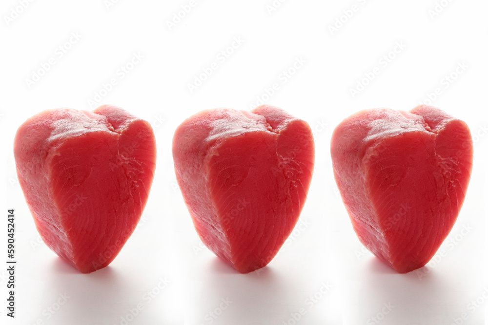 Steaks of fresh tuna fillet on a white background. A pattern of tuna slices. Chunks of tuna in the shape of a hearIsolated object.t. Steaks of fresh tuna fillet on a white background. A pattern of tuna slices. Chunks of tuna in the shape of a hearIsolated object.t.