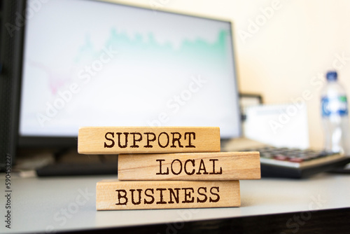 Wooden blocks with words 'Support local business'. Business concept