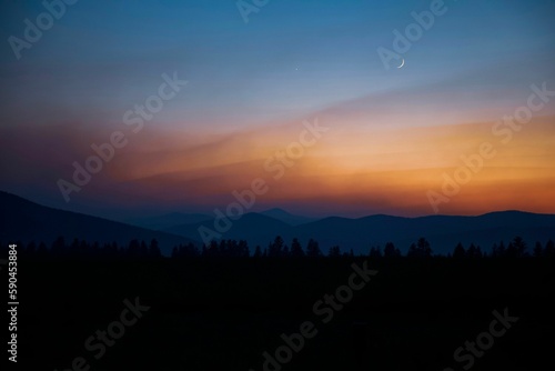 Silhouette of trees on hills on the sunset in Montana