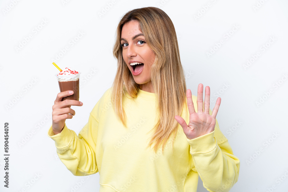 Young Uruguayan woman holding Frappuccino isolated on white background counting five with fingers Young Uruguayan woman holding Frappuccino isolated on white background counting five with fingers