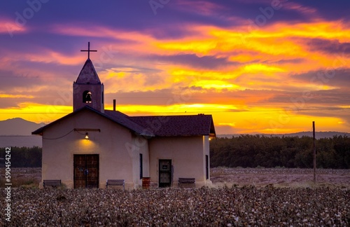 Mesmerizing shot of a church in the countryside during the orange sunset