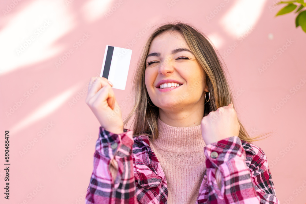 Young pretty Romanian woman holding a credit card at outdoors Young pretty Romanian woman holding a credit card at outdoors