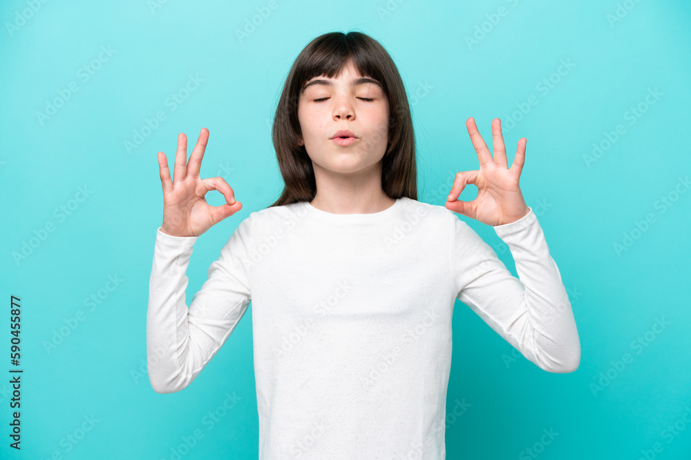 Little caucasian girl isolated on blue background in zen pose Little caucasian girl isolated on blue background in zen pose