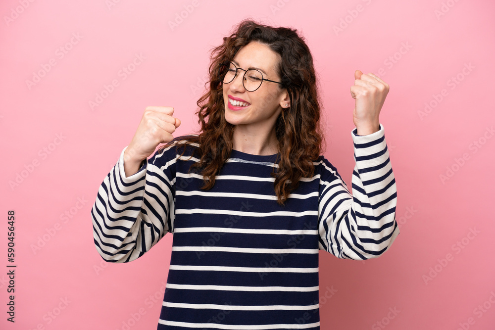 Young caucasian woman isolated on pink background celebrating a victory Young caucasian woman isolated on pink background celebrating a victory