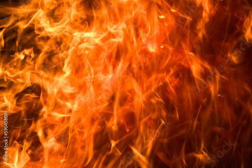 A close-up of a burning orange and yellow flame creates hot atmosphere.