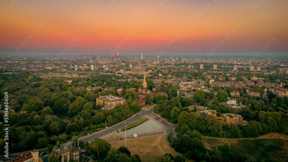Aerial view of the Whitestone Walk, Hampstead with tall buildings and trees at sunset