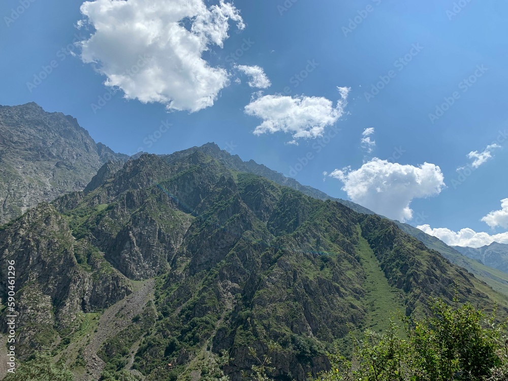 Scenic view of green mountains in Kazbegi, Georgia near the Gergeti Trinity Church