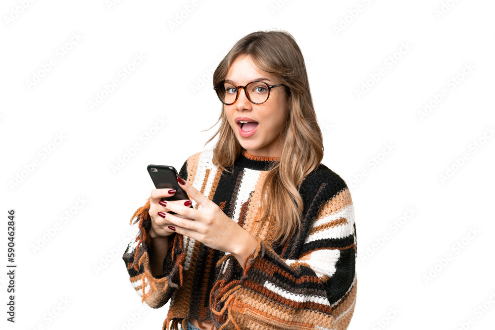 Young girl over isolated chroma key background surprised and sending a message Young girl over isolated chroma key background surprised and sending a message