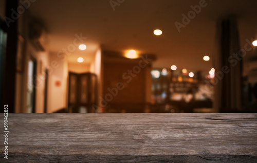 Empty dark wooden table in front of abstract blurred bokeh background of restaurant . can be used for display or montage your products.Mock up for space.