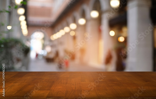 Empty dark wooden table in front of abstract blurred bokeh background of restaurant . can be used for display or montage your products.Mock up for space.