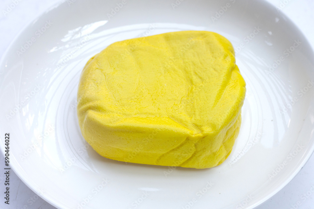 Yellow tofu on white background.