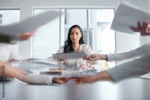 Business woman, anxiety and stress in a meeting or busy office with documents or paperwork. Professional female manager at table with team hands for stress, depression or burnout for deadline crisis photo
