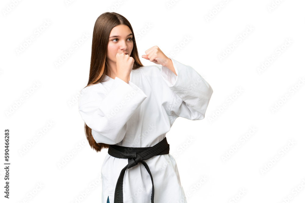 Teenager girl over isolated chroma key background doing karate Teenager girl over isolated chroma key background doing karate