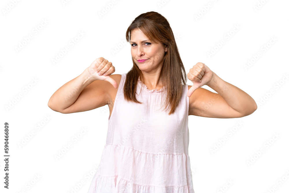 Middle age woman over isolated background showing thumb down with two hands Middle age woman over isolated background showing thumb down with two hands