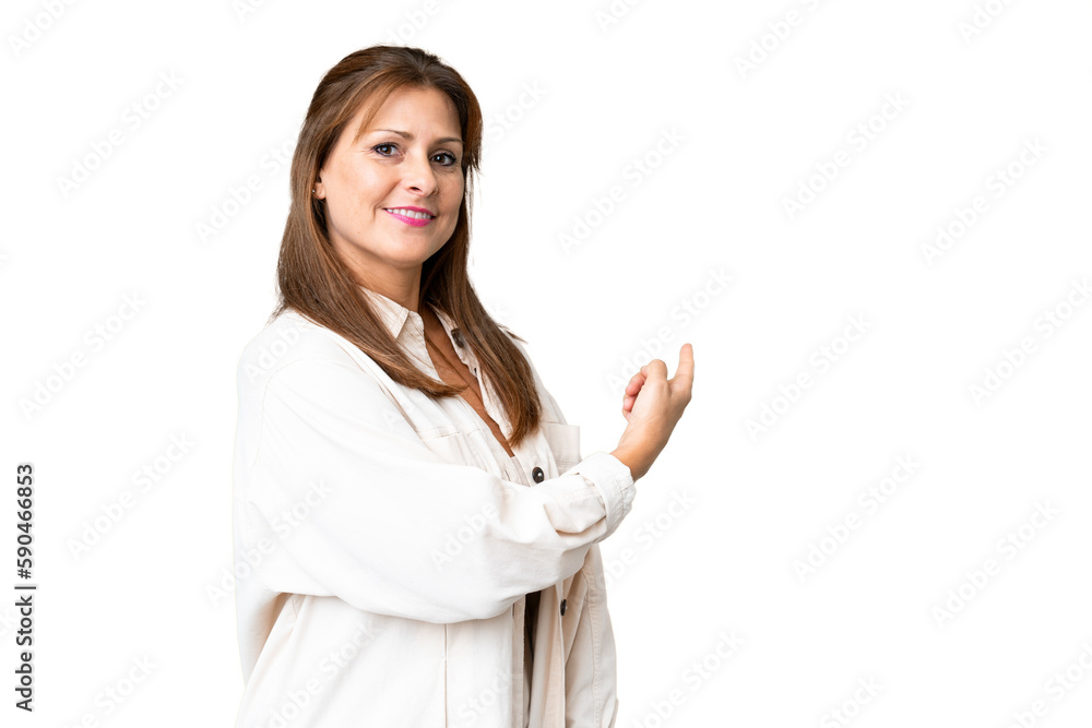 Middle age woman over isolated background pointing back Middle age woman over isolated background pointing back