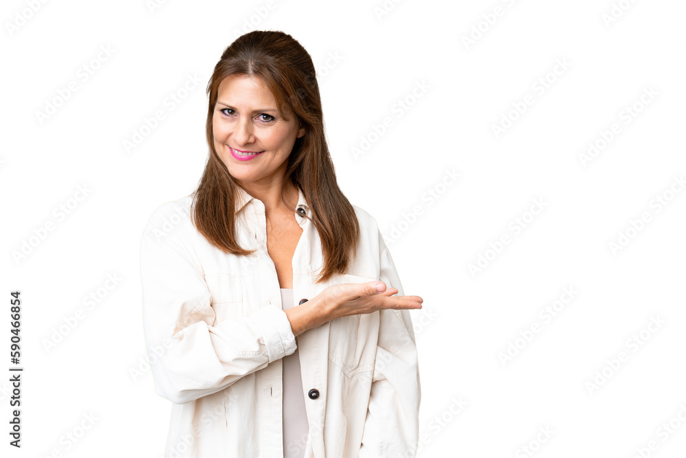 Middle age woman over isolated background presenting an idea while looking smiling towards Middle age woman over isolated background presenting an idea while looking smiling towards