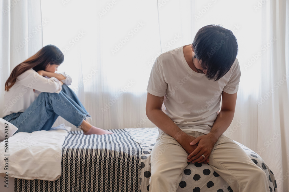 Fototapeta premium The husband is unhappy and disappointed in the erectile dysfunction during sex while his wife sleeping on the bed. Sexual Problems in Men, The concept of erectile dysfunction according.