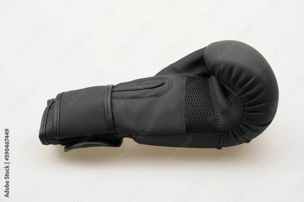 Single black boxing glove isolated on a white background Single black boxing glove isolated on a white background
