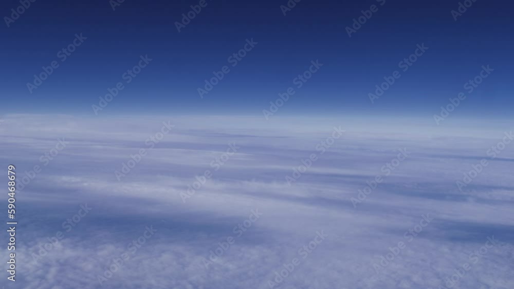Shot of a white cloud surface and blue sky from a plane window Shot of a white cloud surface and blue sky from a plane window