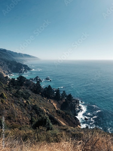 Aerial view of cliffs facing the sea on a sunny morning in California © Maria Isaeva/Wirestock Creators