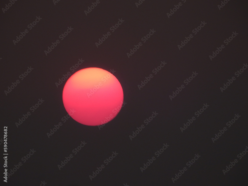 red sun of sunset on black sky background red sun of sunset on black sky background