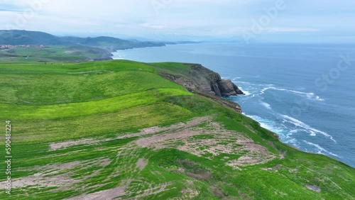 Coastal landscape of cliffs, meadows and sea in the area of Punta Ballota between Tagle and Ubiarco. Aerial view from a drone. Cantabrian Sea. Cantabria, Spain, Europe photo