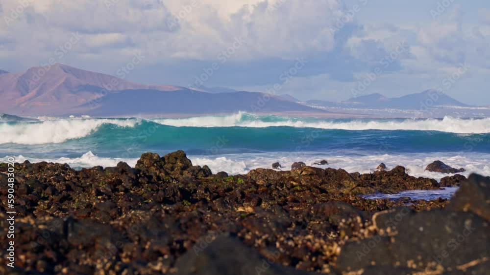 The waves crash against the stone shore The waves crash against the stone shore