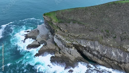 Coastal landscape of cliffs, meadows and sea in the area of Punta Ballota between Tagle and Ubiarco. Aerial view from a drone. Cantabrian Sea. Cantabria, Spain, Europe photo