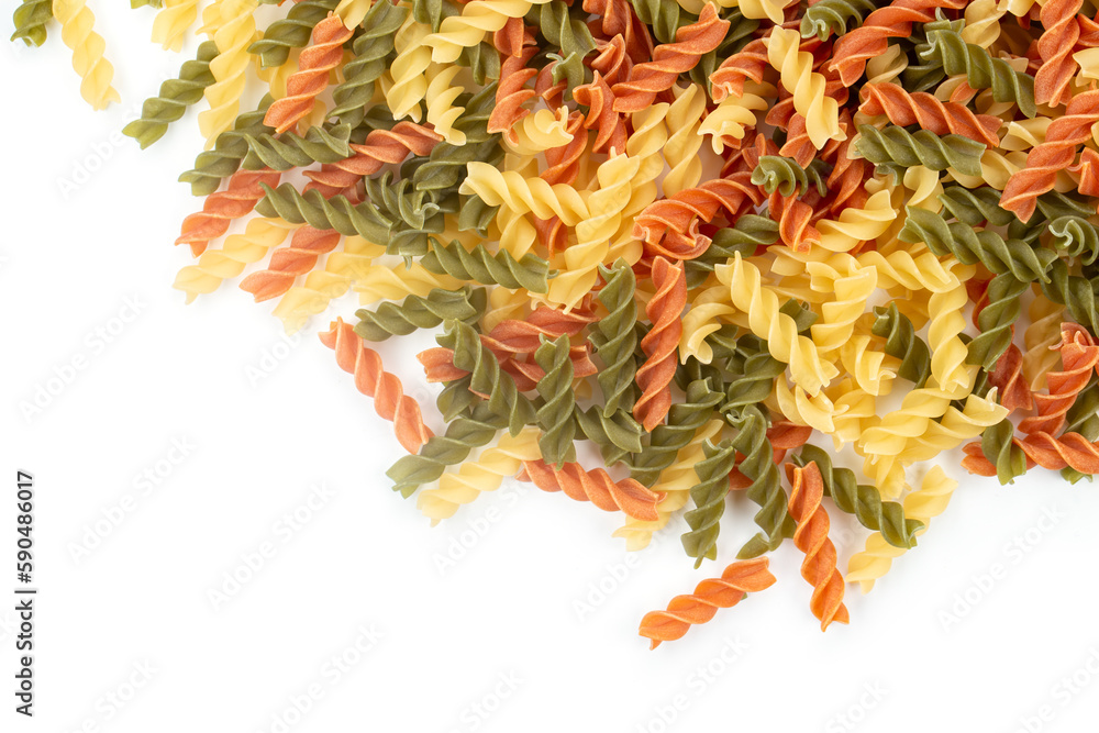 Raw colored pasta fusilli on white background. Space for text. Raw colored pasta fusilli on white background. Space for text.