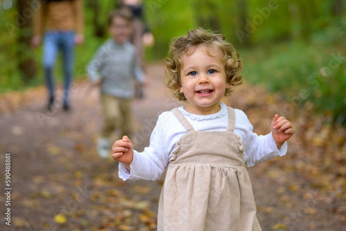 Little laughing girl in the forest