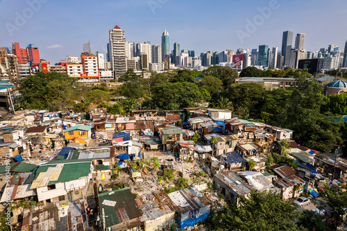 Metro Manila, Philippines - A squatter colony contrasts with the modern BGC skyline. Concept of inequality. photo