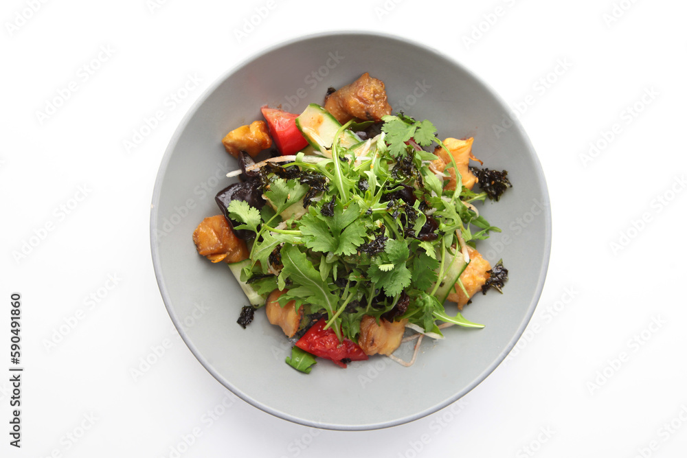 Baked eggplant with arugula, tomatoes and cucumbers. Salad with baked eggplant. Plate on a white background. Isolated object.Flat lay. Top view. Copy space. Baked eggplant with arugula, tomatoes and cucumbers. Salad with baked eggplant. Plate on a white background. Isolated object.Flat lay. Top view. Copy space.