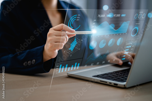 Fototapeta Naklejka Na Ścianę i Meble -  Businessmen pointing to charts and data business on a visual screen dashboard with laptop, technology devices and screens visible in the background, financial planning, market research, stock market.