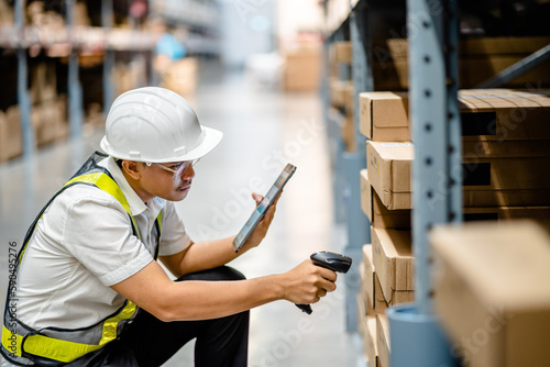 Warehouse workers use scanner checking and scan the barcode of stock inventory to keep storage in a system, Smart warehouse management system, Supply chain and logistic network technology concept.
