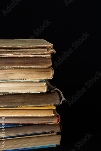 Stack of hardcover old books with on a dark background. Bookshelf shop, Knowledge publications, literature. Bookish bookstore bookstore