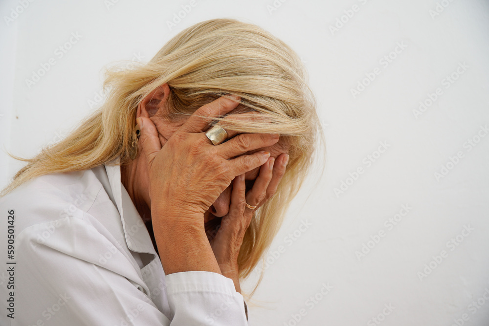 portrait of sad senior female doctor and depression covering her face with her hands. Psychological problems and mental health portrait of sad senior female doctor and depression covering her face with her hands. Psychological problems and mental health