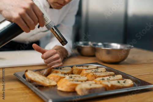 Professional chef frying croutons with spices using a flame gun healthy food concept breakfast lunch