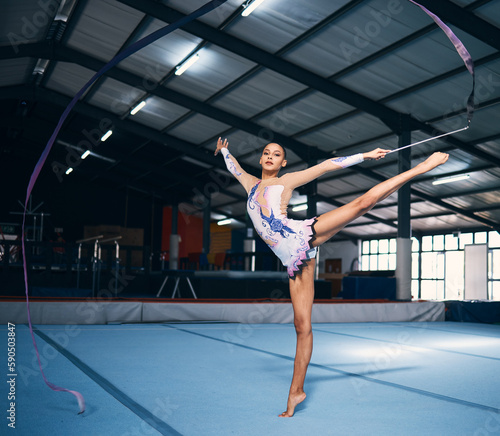 фотографія Ribbon, gymnastics and portrait of woman balance in performance, dance training and sports competition