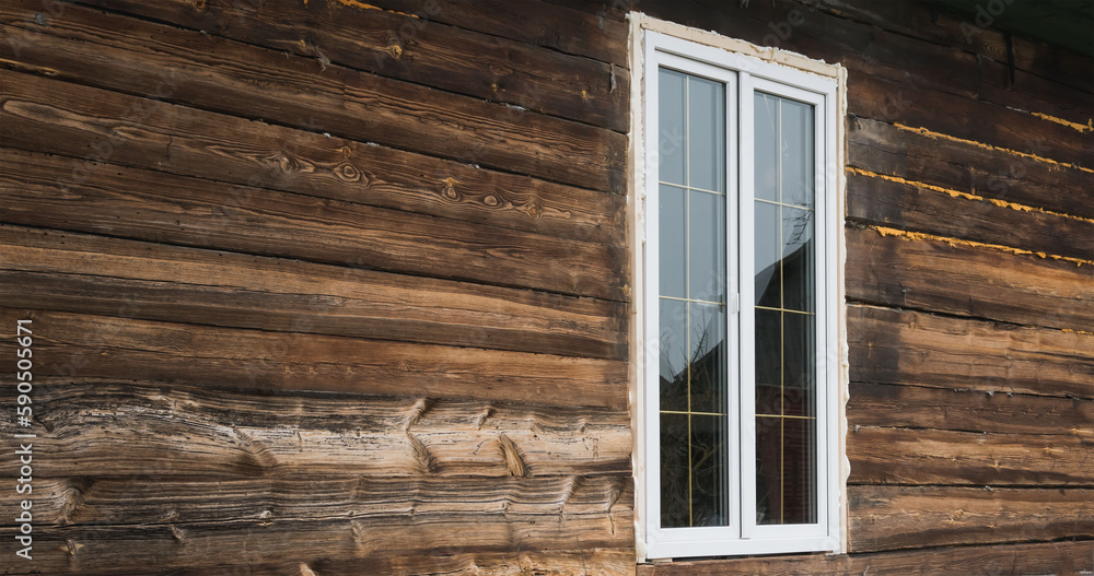 A large window is installed in an old building A large window is installed in an old building