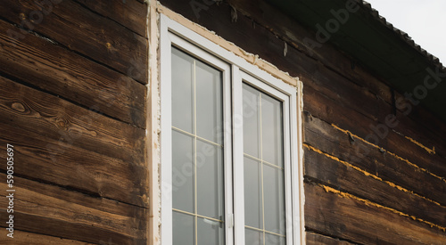 A large window is installed in an old building