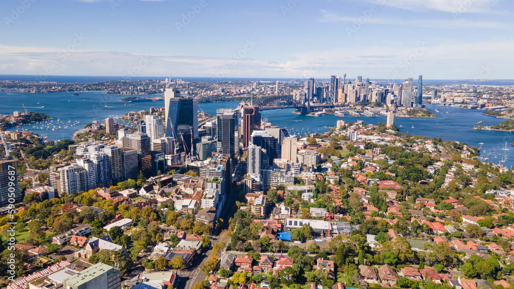 Aerial drone panoramic view of North Sydney with Sydney Harbour and Sydney City CBD in the background on a sunny morning in April 2023       