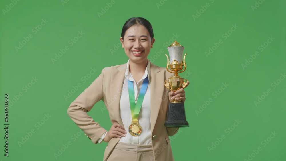Asian Business Woman In A Suit With A Gold Medal And Trophy Smiling To ...
