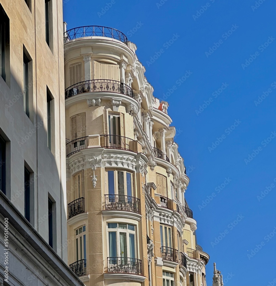 Facade of a building. Blue sky. Tall, multi-storey