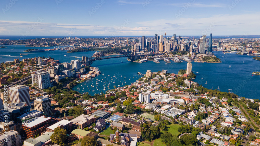 Obraz premium Aerial drone panoramic view of Sydney City and Sydney Harbour looking from above North Sydney on a sunny morning in April 2023 