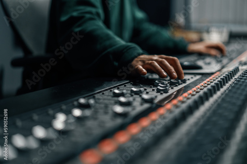 Sound engineer used digital audio mixer Sliders Engineer presses keys Control panel Recording studio technician