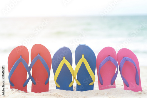 sea on the beach Footprint people on the sand and slipper of feet in sandals shoes on beach sands background. travel holidays concept.