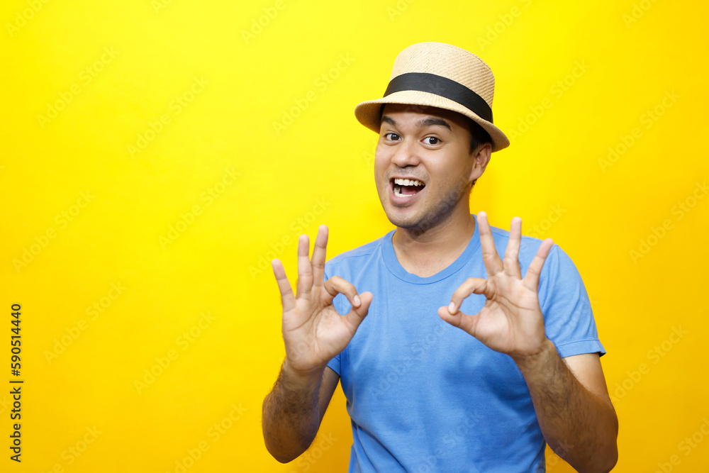 Portrait of Hipster young man young happy man casual dress blue striped t-shirt and wear a hats. Gesture emotion extend the arms shy modest on studio portraits set color yellow background. Portrait of Hipster young man young happy man casual dress blue striped t-shirt and wear a hats. Gesture emotion extend the arms shy modest on studio portraits set color yellow background.