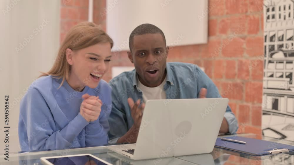Excited Interracial Couple Celebrating Success on Laptop Excited Interracial Couple Celebrating Success on Laptop