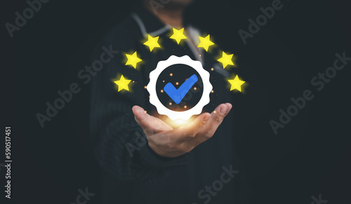 Concept of guarantee standards iso certification and standardization service quality and assurance : Businessman Is using finger touching for certify with five star after he has verified it...